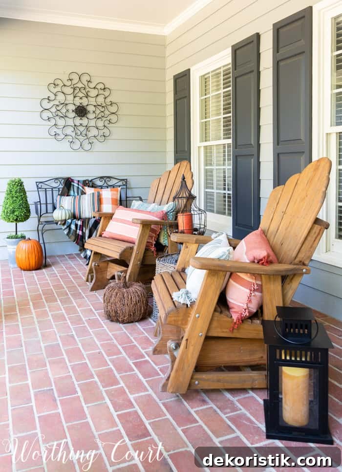 front porch with Adirondack gliders decorated for fall