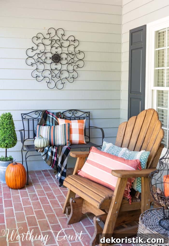 front porch with Adirondack gliders decorated for fall