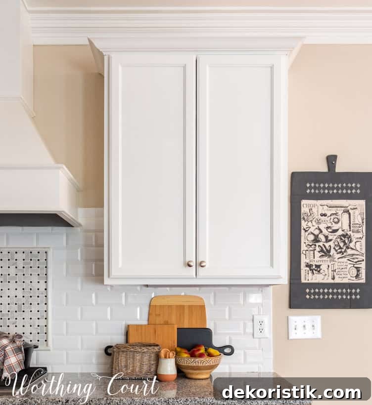 fall decor in kitchen with white cabinets and granite counters