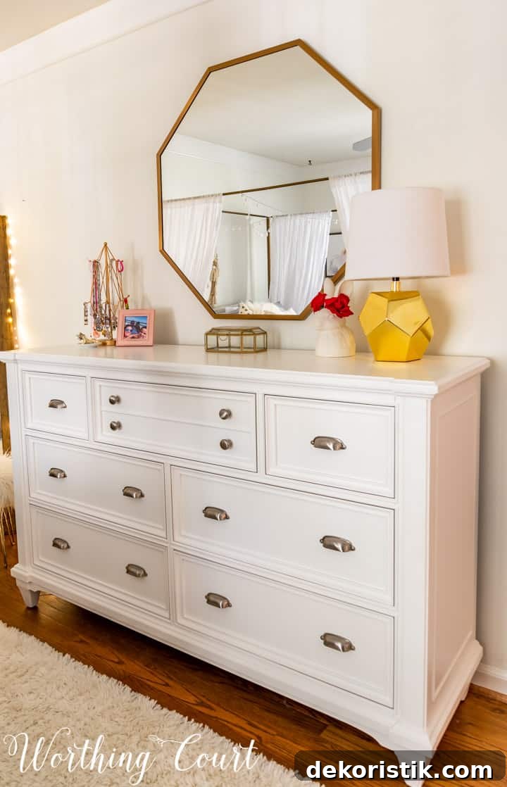 white dresser with octagonal mirror above