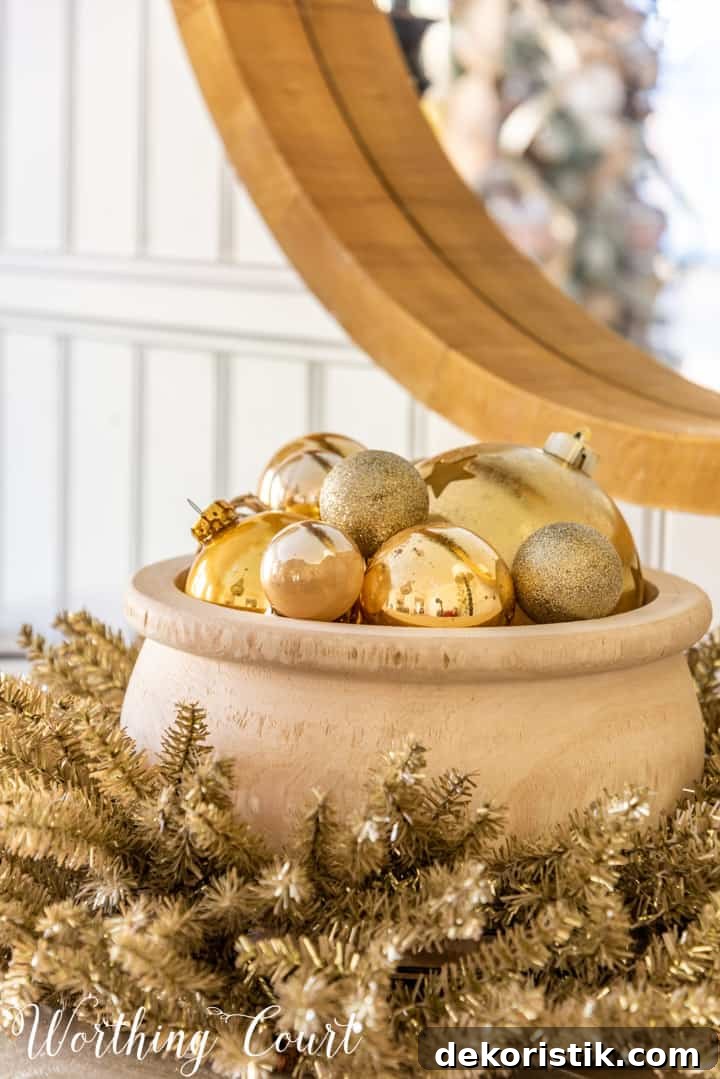 Rustic Christmas Dining Room Decor Ideas for Elegant Tables 18 wood bowl filled with gold Christmas ornaments nestled in a tinsel wreath
