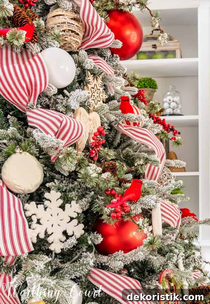 Red and White Flocked Christmas Tree with Snowy Branches 9 partial view of Christmas tree with red and white decorations