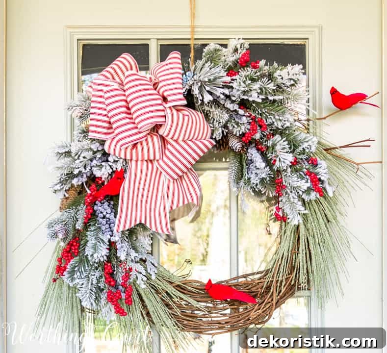 Christmas wreath with faux greenery, cardinals and red and white bow