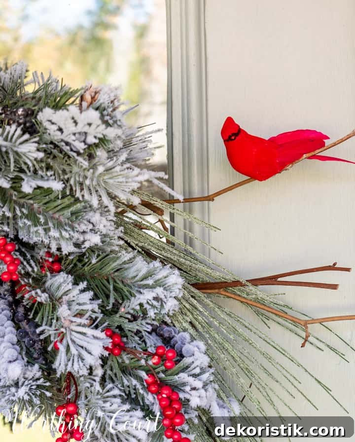 faux cardinal on a branch in a Christmas wreath