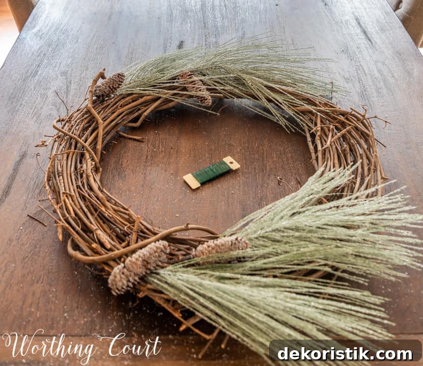 partially assembled Christmas wreath lying on a table