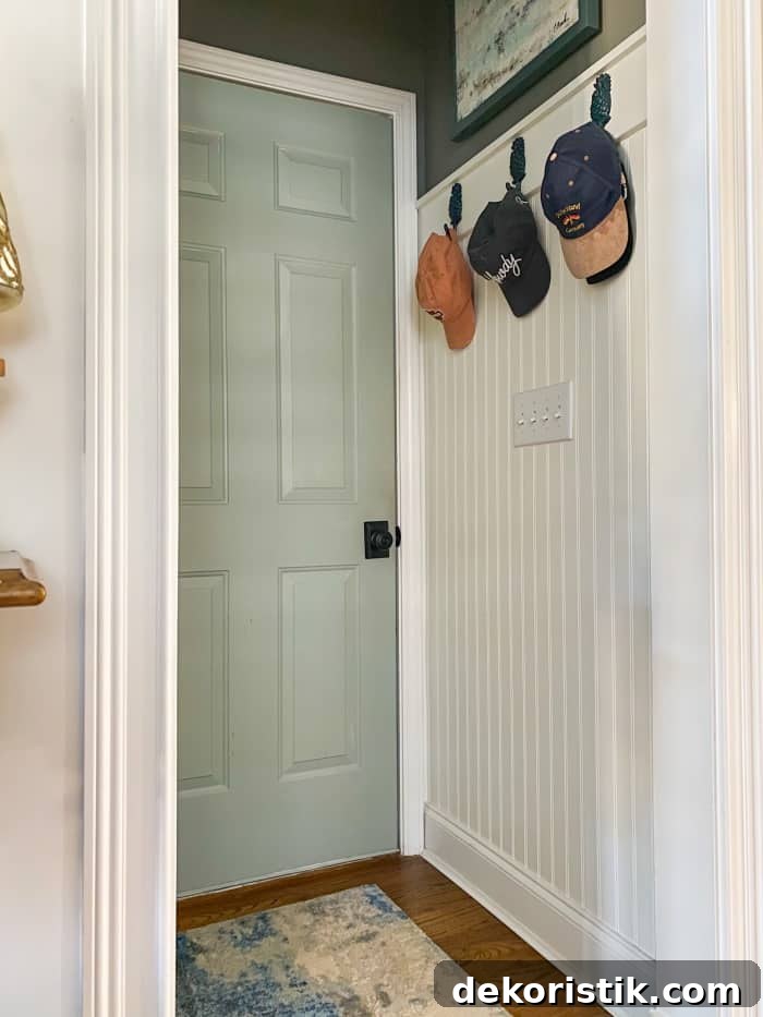 hallway with white walls and blue door