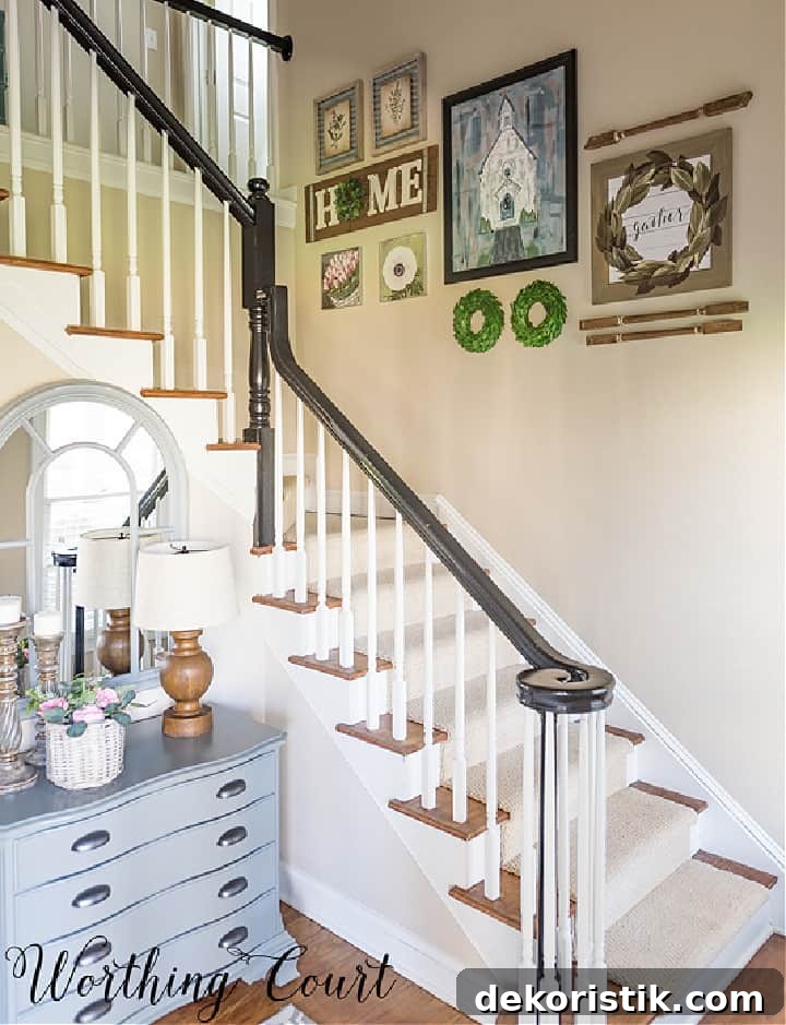 stairway with black handrail, white pickets and a gallery wall
