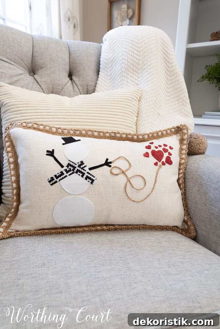 pillow with snowman and red hearts in a gray chair