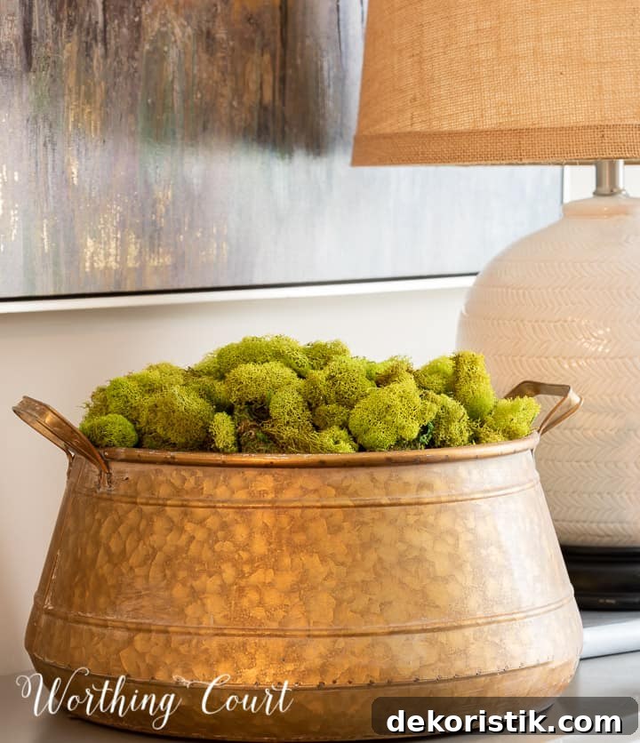 brass bowl filled with green moss on a small chest