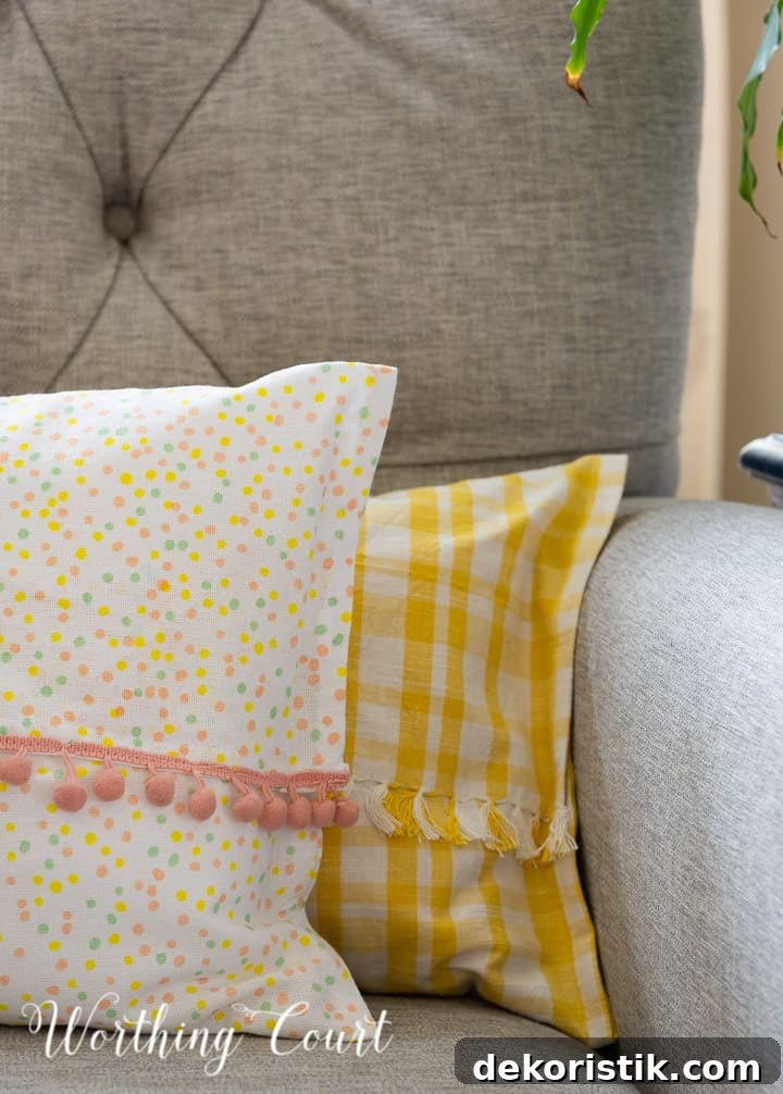 yellow and white and multi colored dots pillows in a gray chair