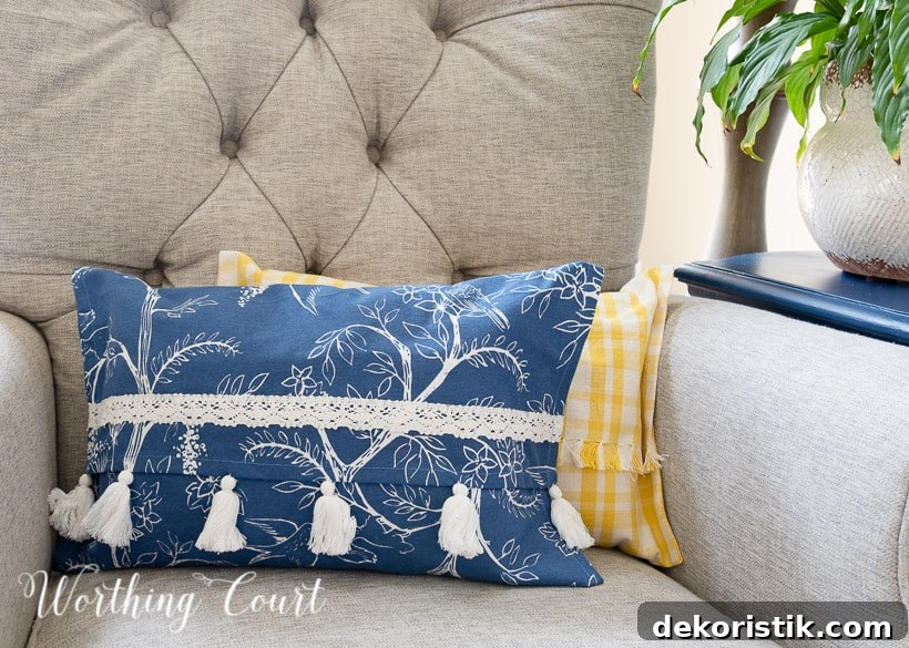 portion of a blue and white and yellow and white pillow in a gray chair