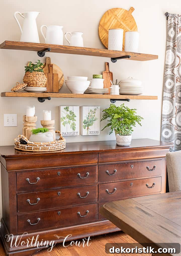 open wood shelves decorated with white dishes, greenery and light wood toned accessories