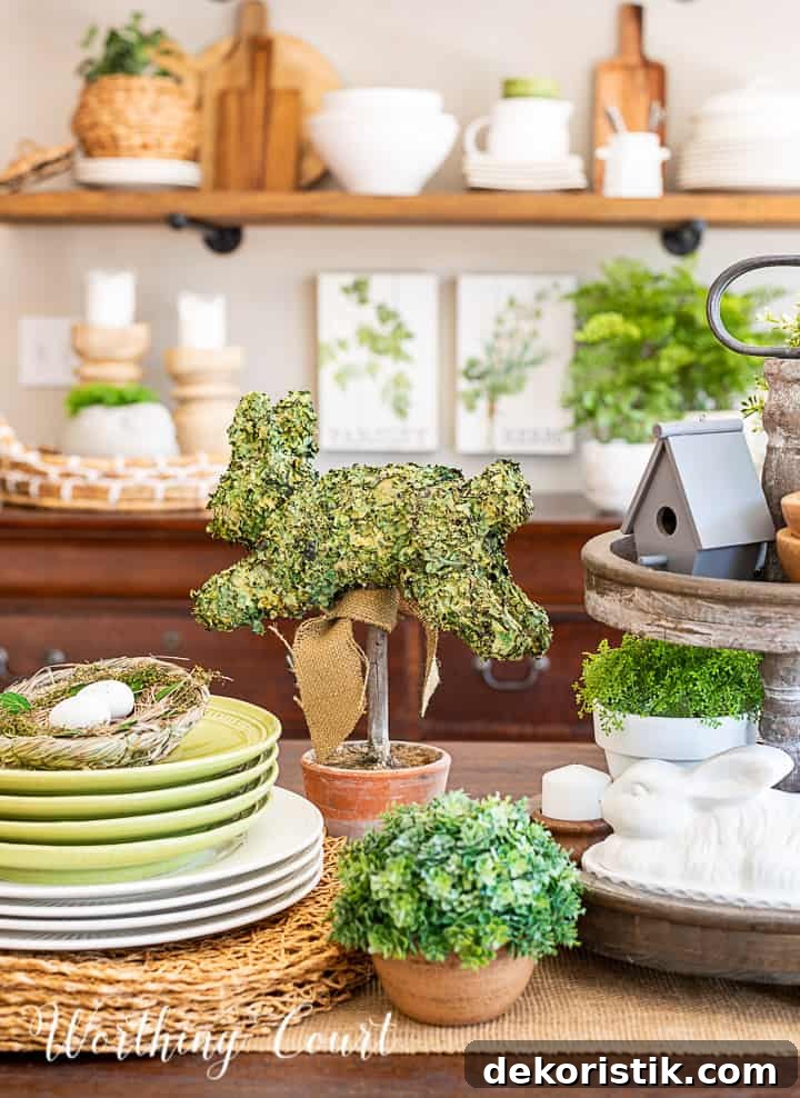 portion of a spring centerpiece with bunnies, greenery and white accessories and dishes