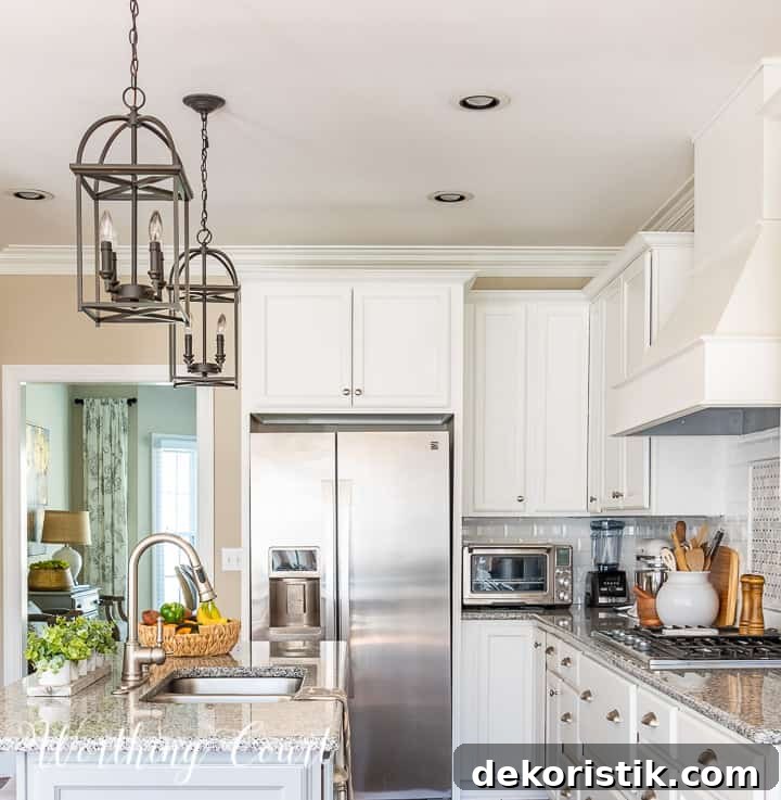 end view of kitchen with white cabinets and gray island