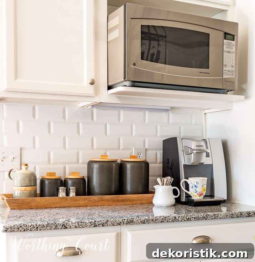 gray canisters and coffee maker in a kitchen with white cabinets and subway tile backsplash