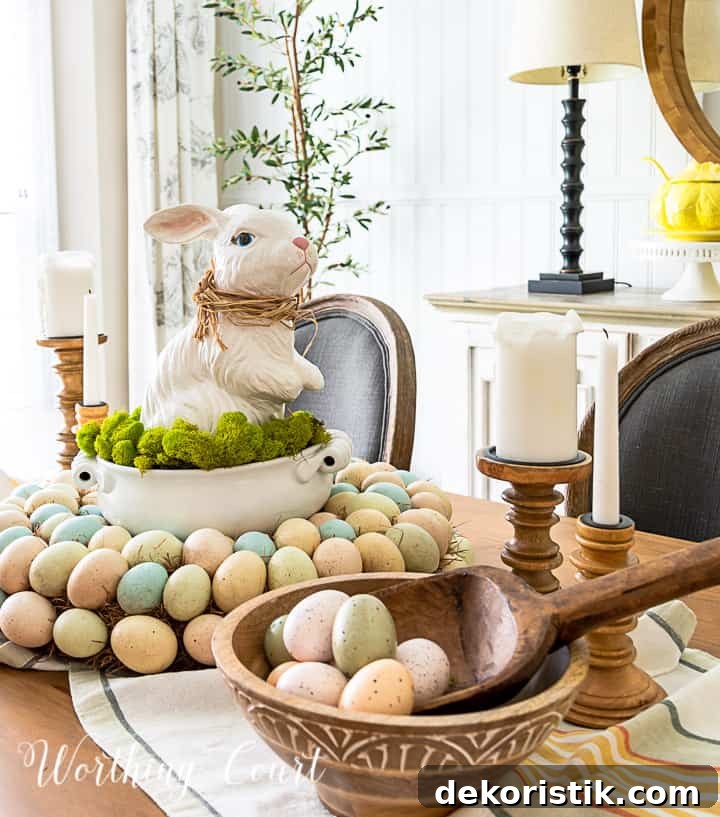 Easter centerpiece with white ceramic bunny in the middle of an egg wreath and a wood bowl filled with faux Easter eggs