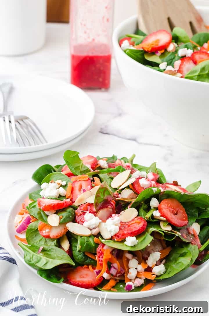 strawberry spinach salad in white bowls