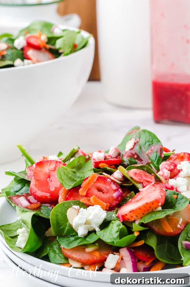 strawberry spinach salad in white bowls