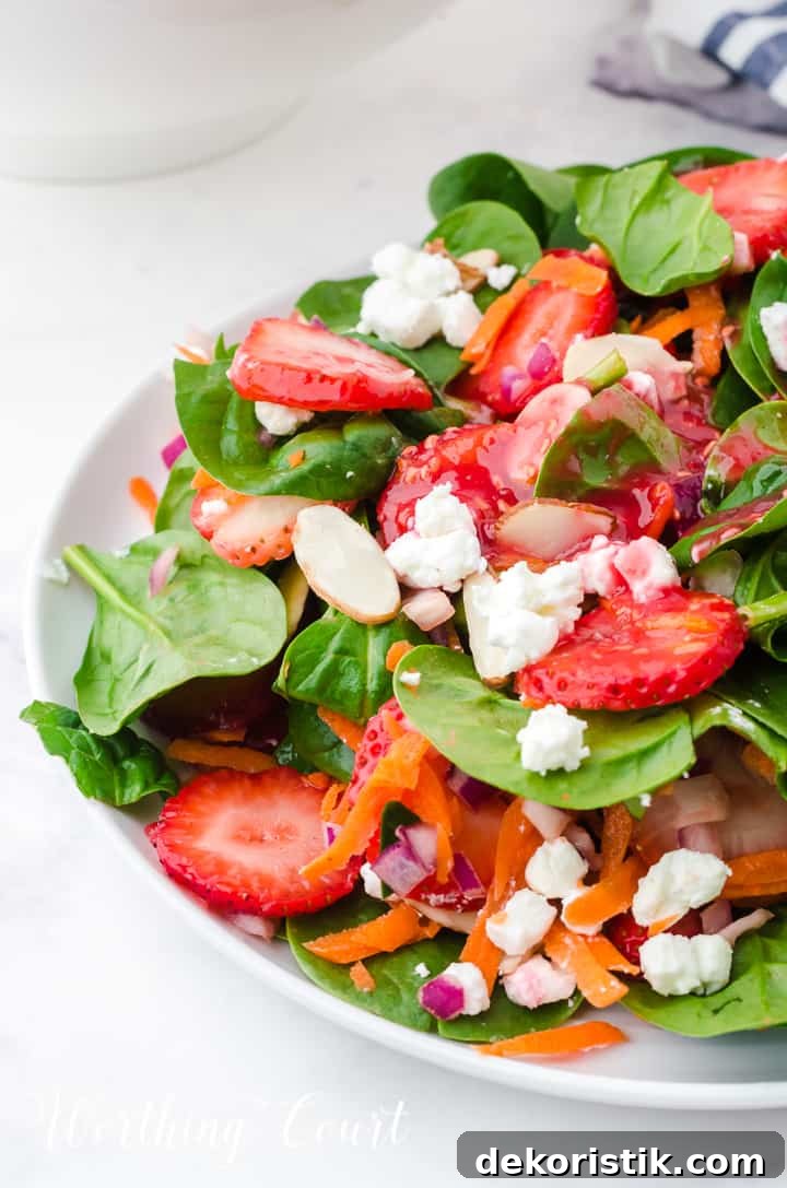 strawberry spinach salad in white bowls