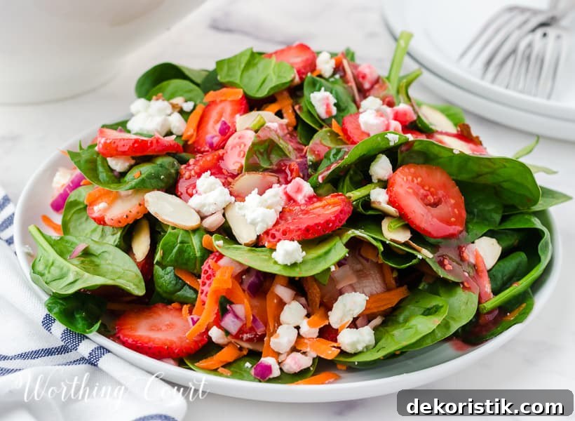 strawberry spinach salad in white bowls