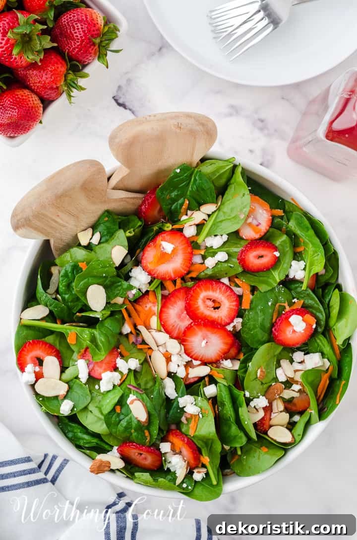 strawberry spinach salad in white bowls