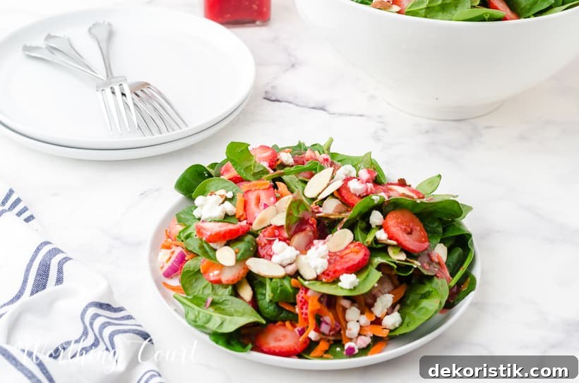 strawberry spinach salad in white bowls