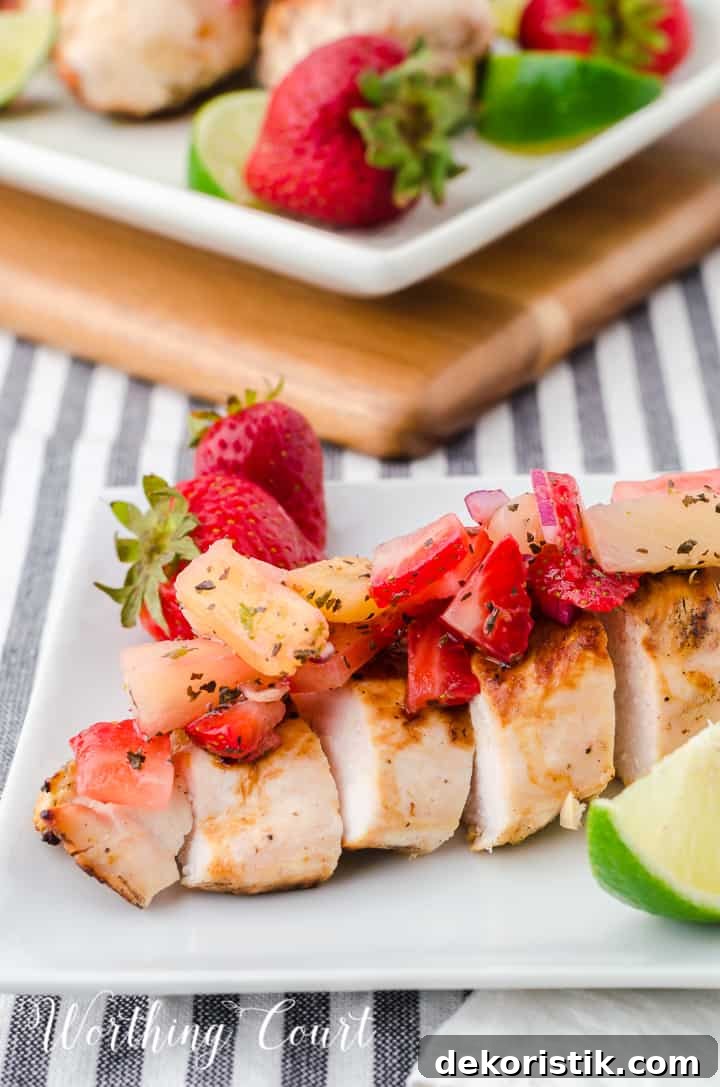 sliced grilled chicken breast topped with strawberry and pineapple salsa