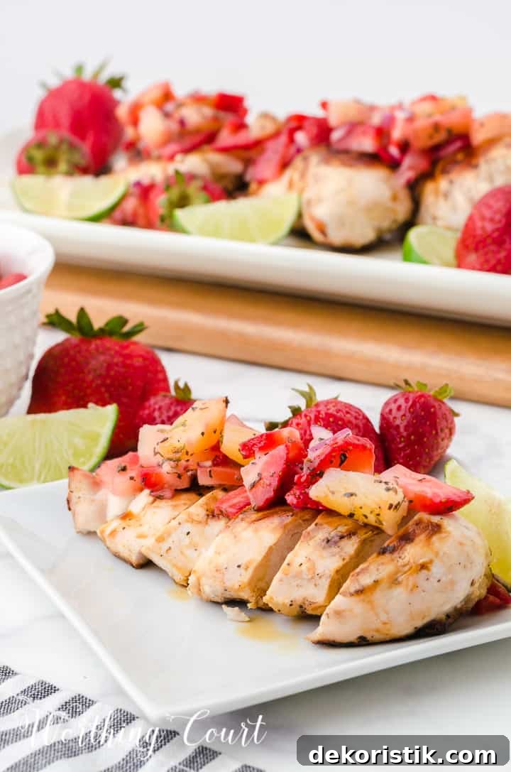 sliced grilled chicken breast topped with strawberry and pineapple salsa