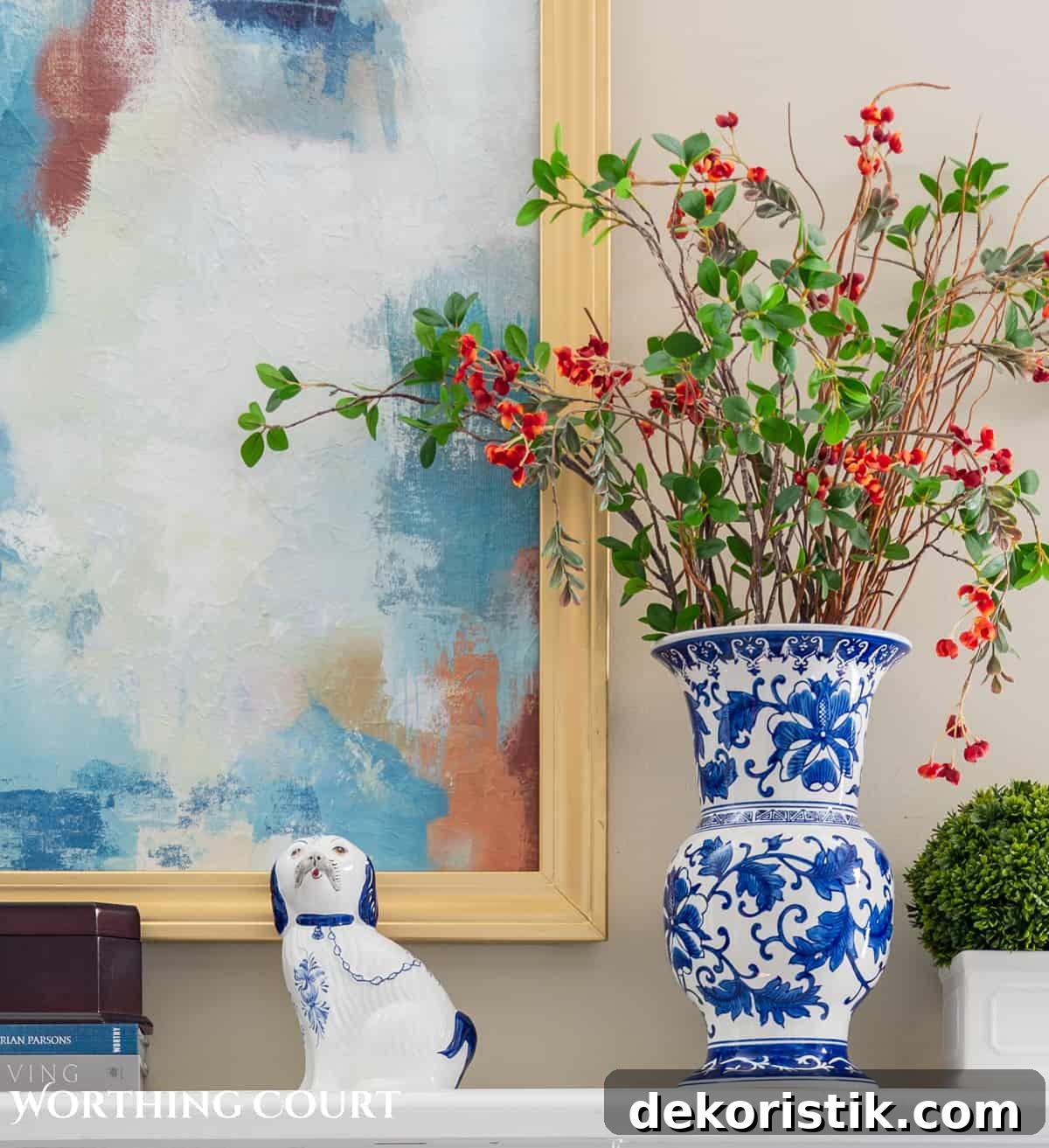 blue and white vase on mantel with faux greenery and florals set against a beige wall