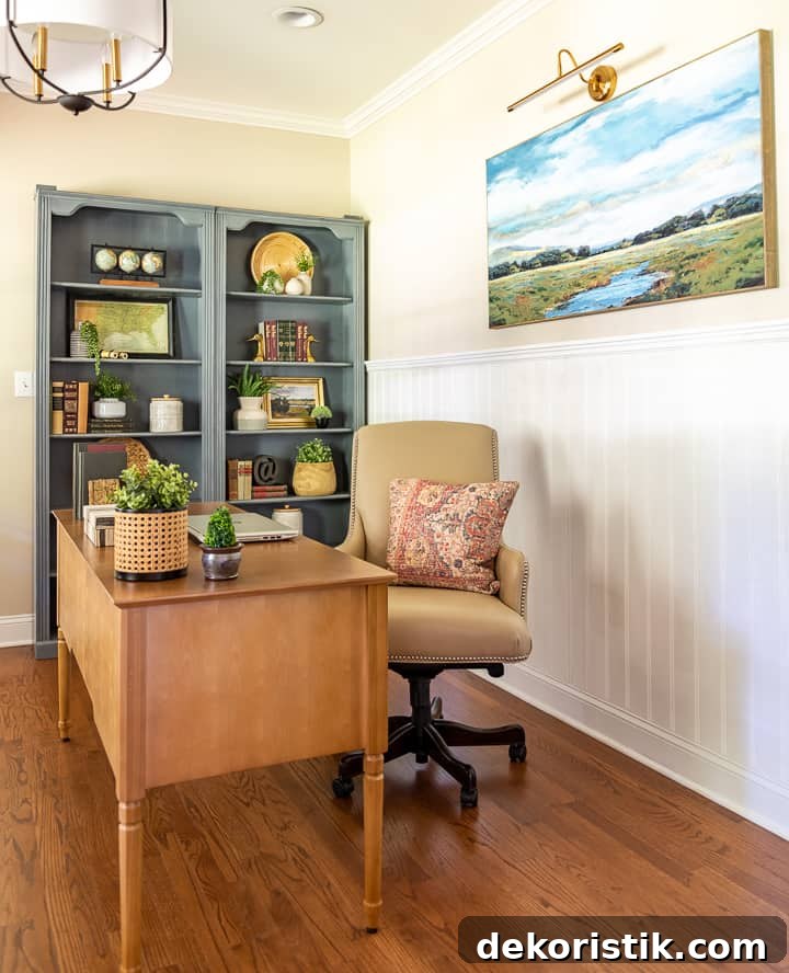natural wood desk with beige leather chair and gray bookcases filled with accessories in background