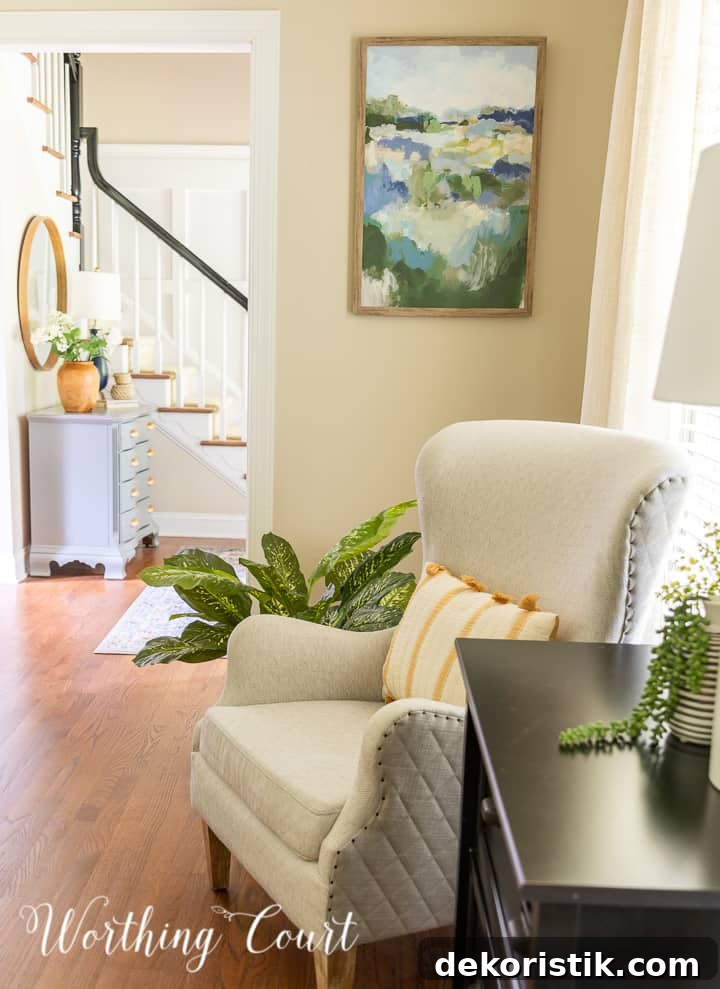 neutral arm chair in front of abstract wall art