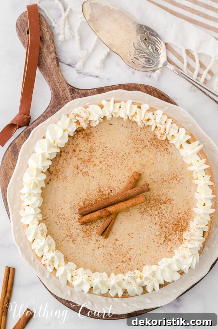 whole gingerbread cheesecake garnished with whipped cream and cinnamon sticks