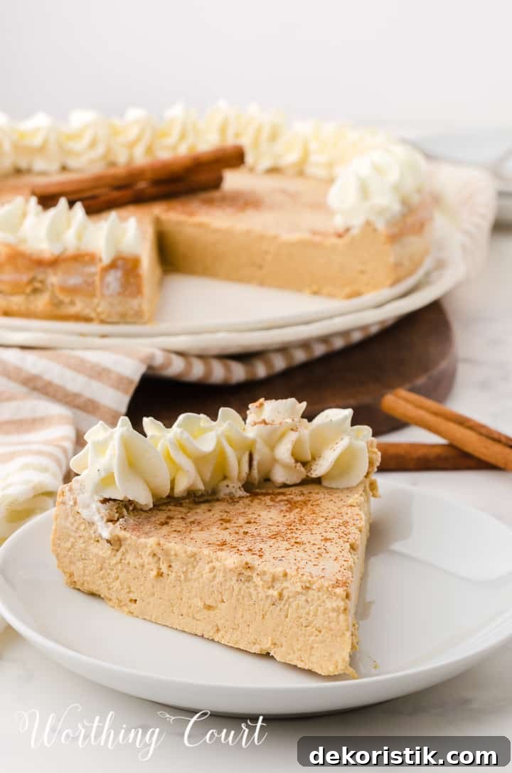individual piece of gingerbread cheesecake with whipped topping garnish in front on whole cheesecake in the background