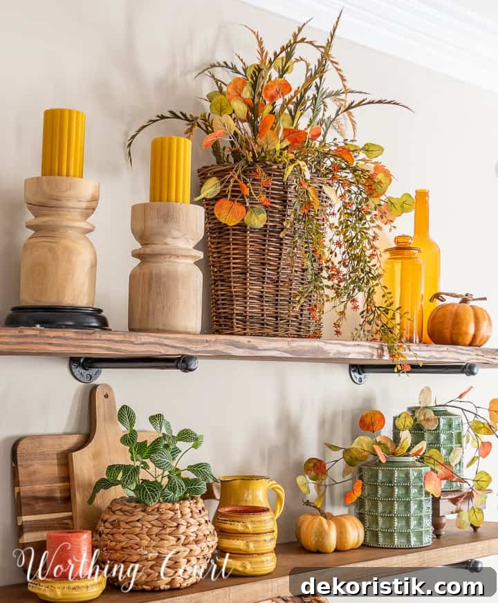 wooden open shelves decorated for fall with rich amber and green accessories