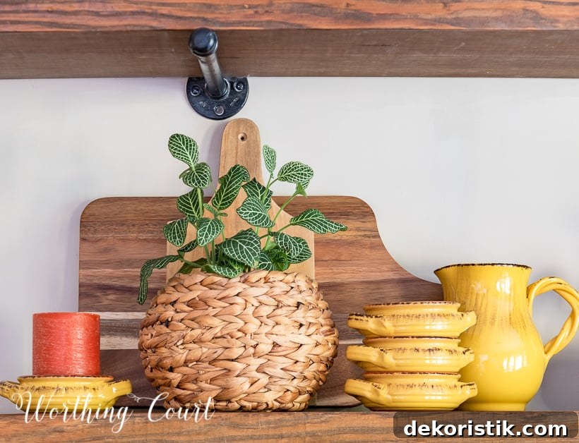 wooden open shelves decorated for fall with rich amber and green accessories