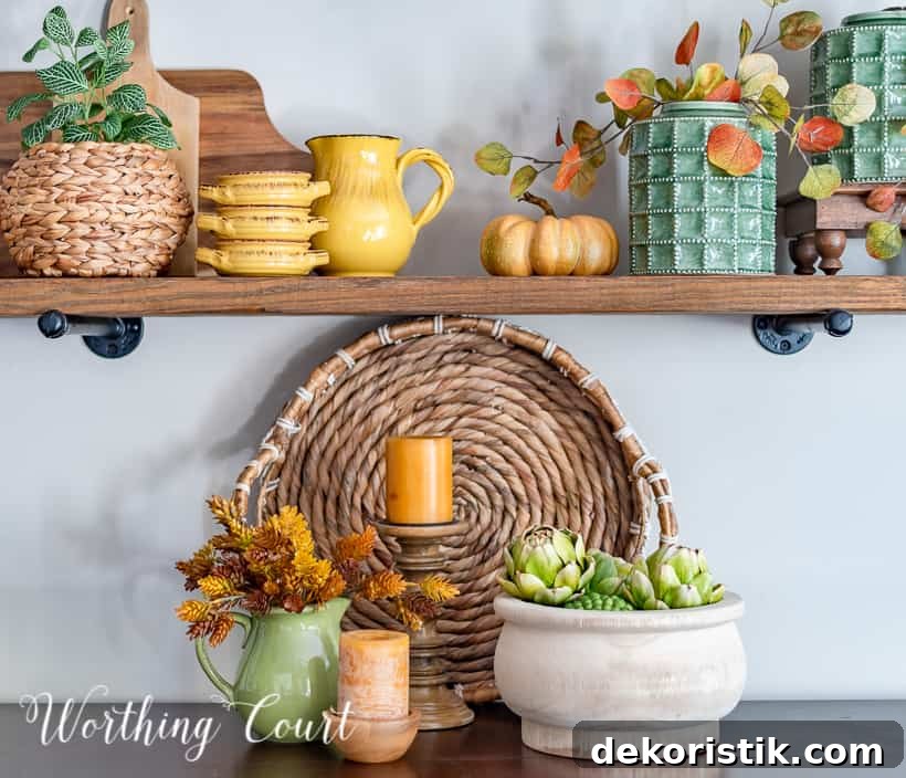 wooden open shelves decorated for fall with rich amber and green accessories