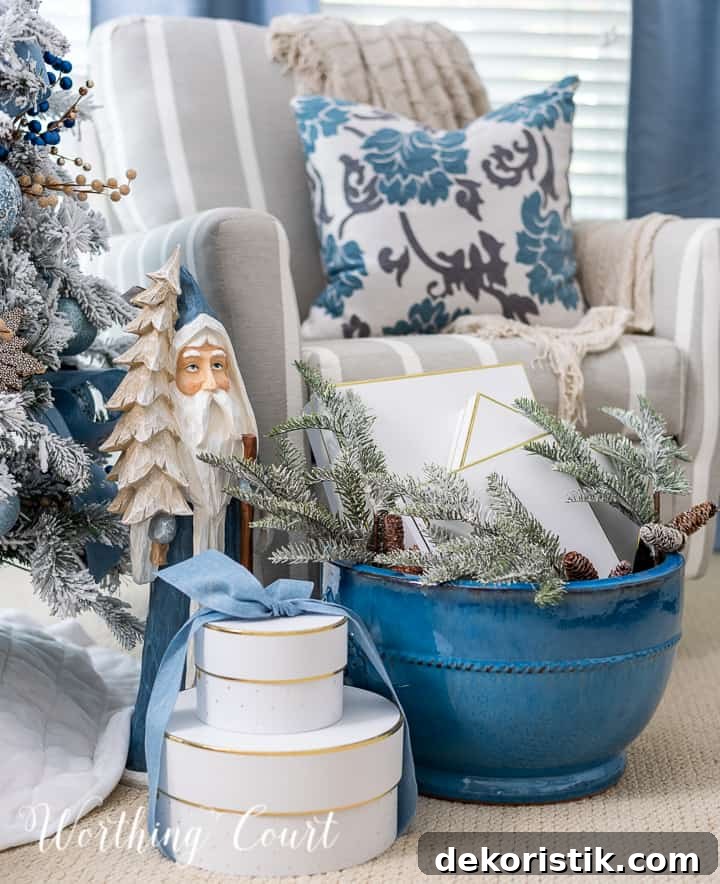 Blue Santa statue beside gifts under a Christmas tree