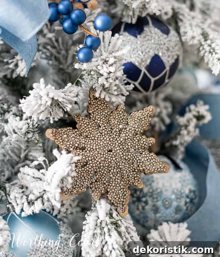 Blue and champagne gold ornaments on a flocked Christmas tree