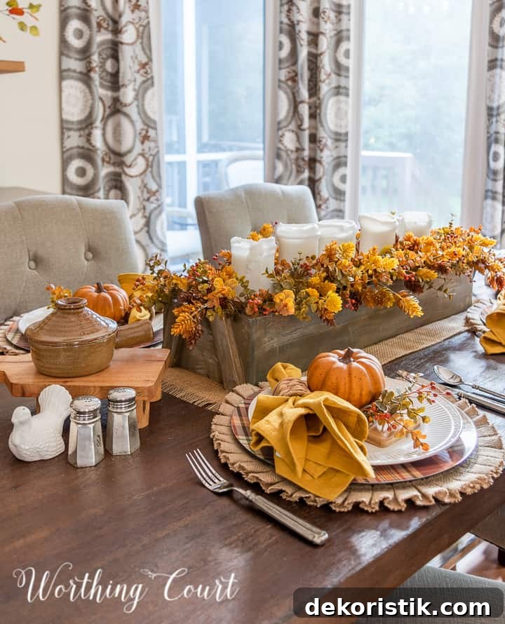 Low wooden box centerpiece with candles and fall foliage
