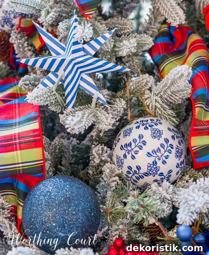 blue white and red decorations on a flocked Christmas tree