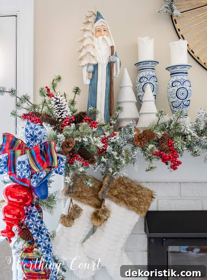Fireplace decorated for Christmas with a garland and blue, red and white decorations