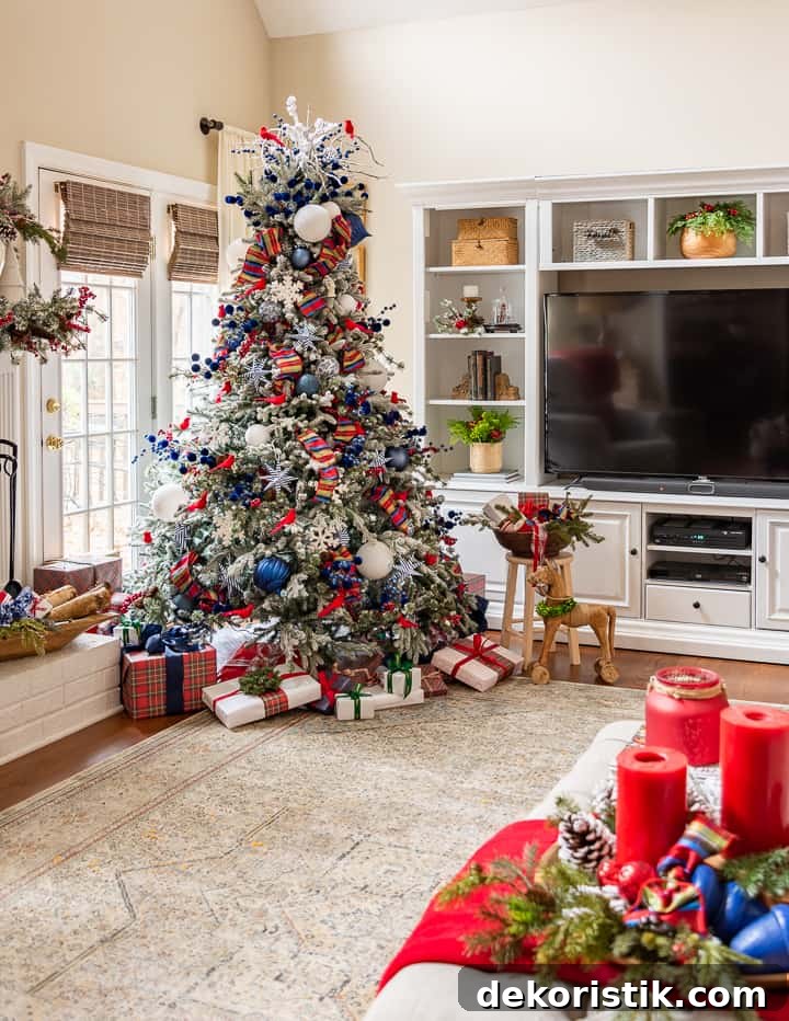 Christmas tree with red and blue decorations beside white entertainment center