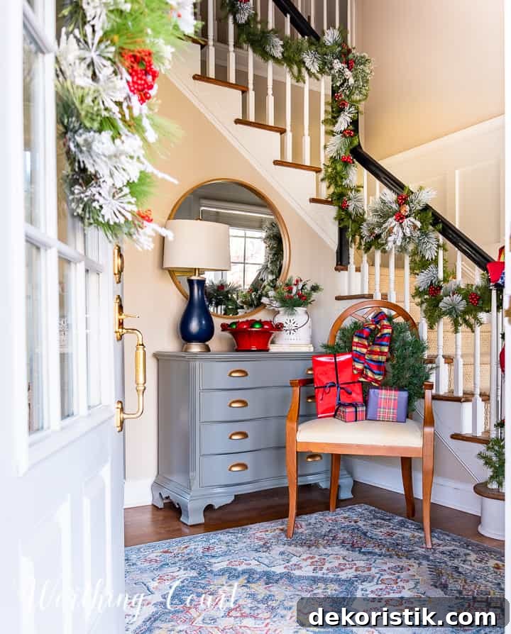 chair in foyer in front of handrail with Christmas garland with red and blue decor