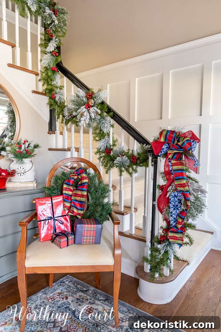 chair in foyer in front of handrail with Christmas garland with red and blue decor