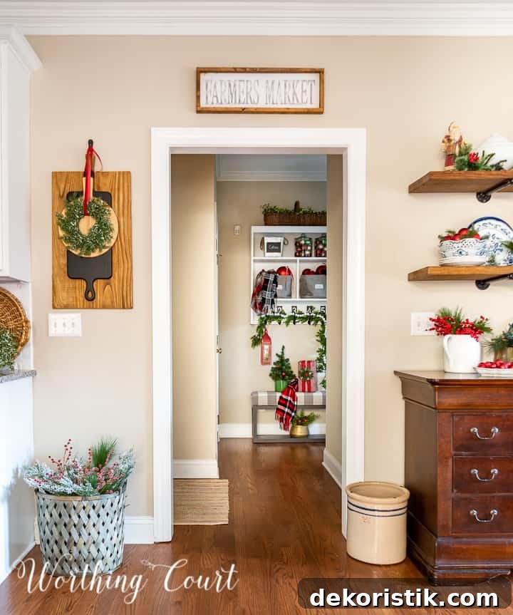 view looking through kitchen into drop zone area decorated for Christmas with traditional decor