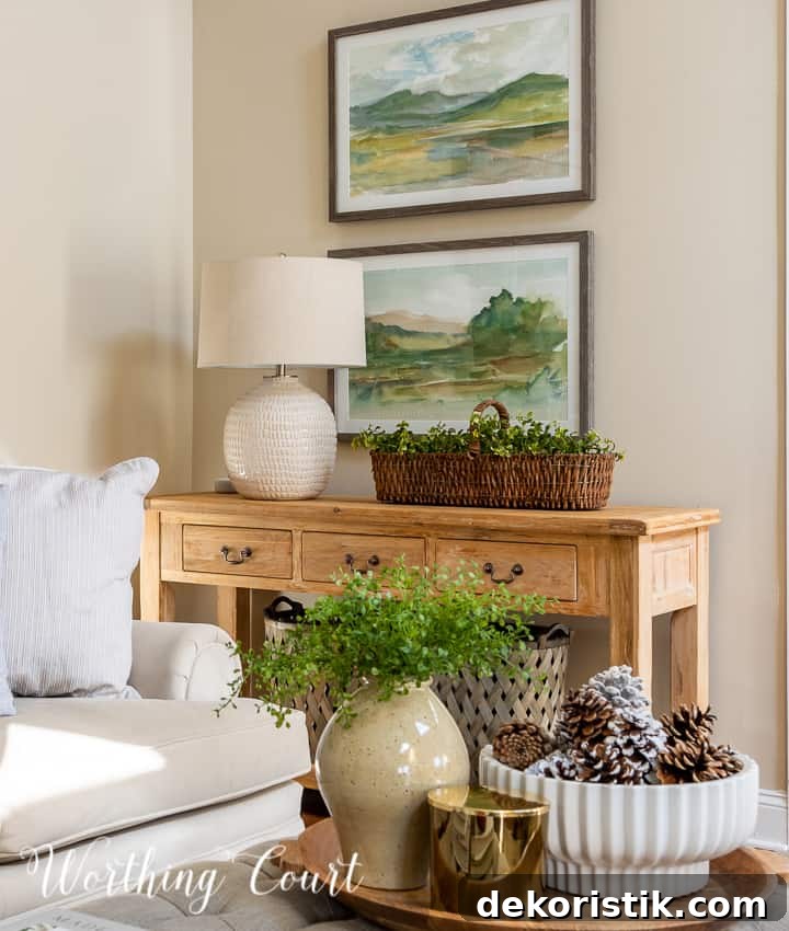 natural wood console table with lamp, landscape art and winter accessories