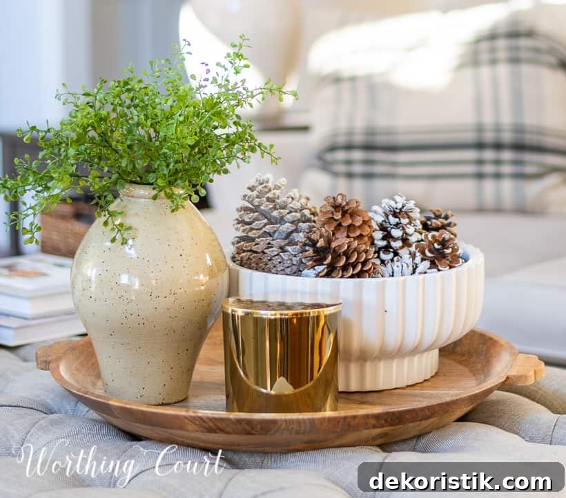 round wood tray on upholstered coffee table with neutral winter decor