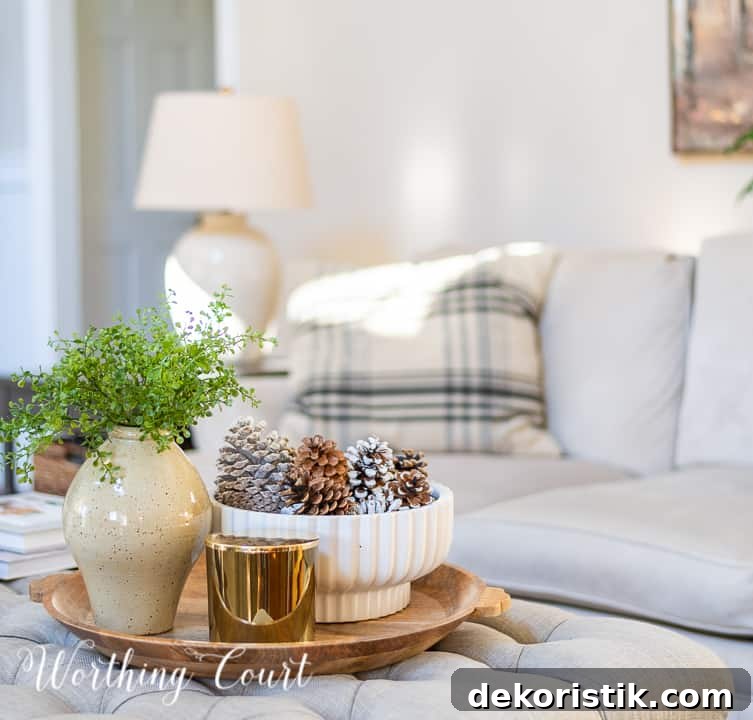 round wood tray on upholstered coffee table with neutral winter decor