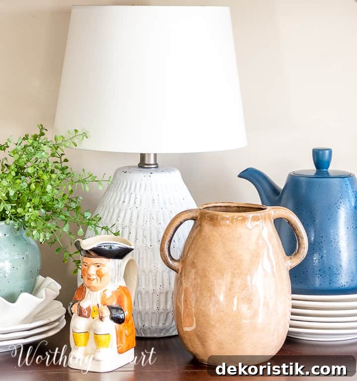 sideboard vignette with small lamp and blue and white accessories