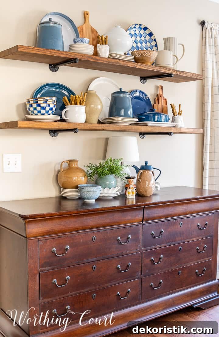 wood open shelves above a sideboard with blue and white accessories